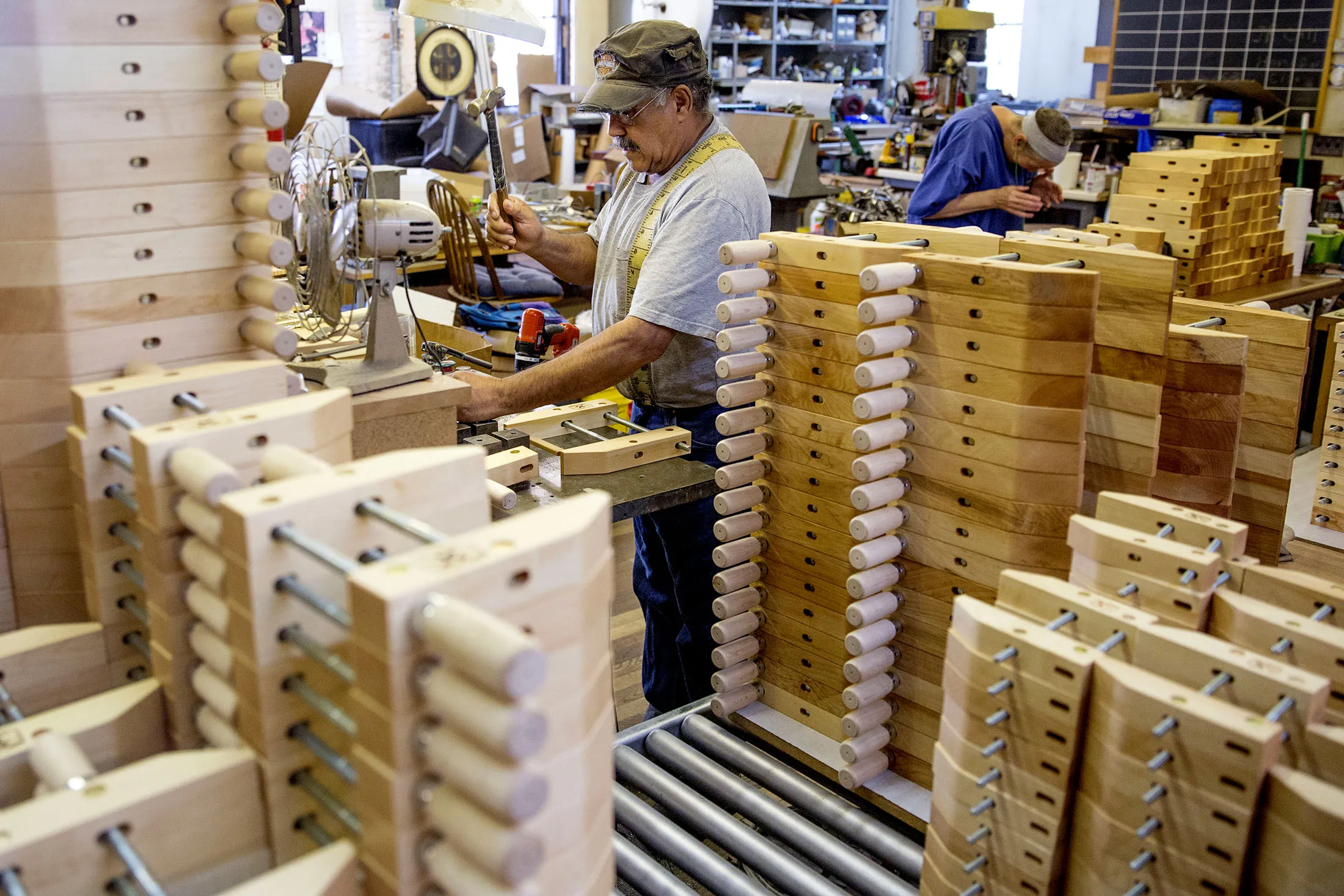 Workers assemble wooden handscrew clamps during production in Dubuque, Iowa, on Aug. 8, 2017.