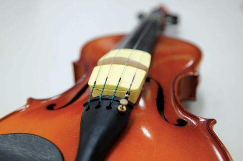 Jamit, a collection of sensors placed on the bridge of a violin that uses Bluetooth to send the player’s performance data to a tablet app.