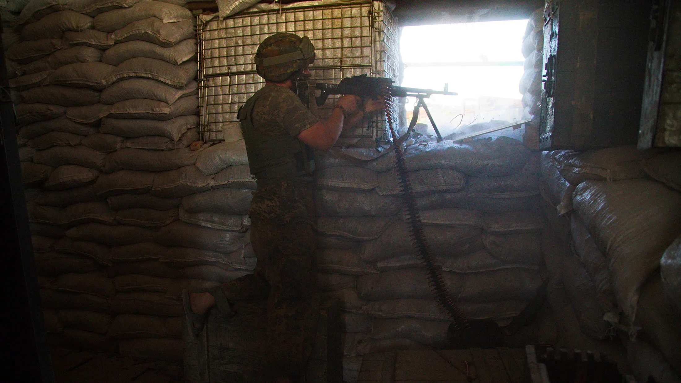 A Ukrainian serviceman shoots on the front line in Opytne village, close to Donetsk airport on June 7, 2015.
