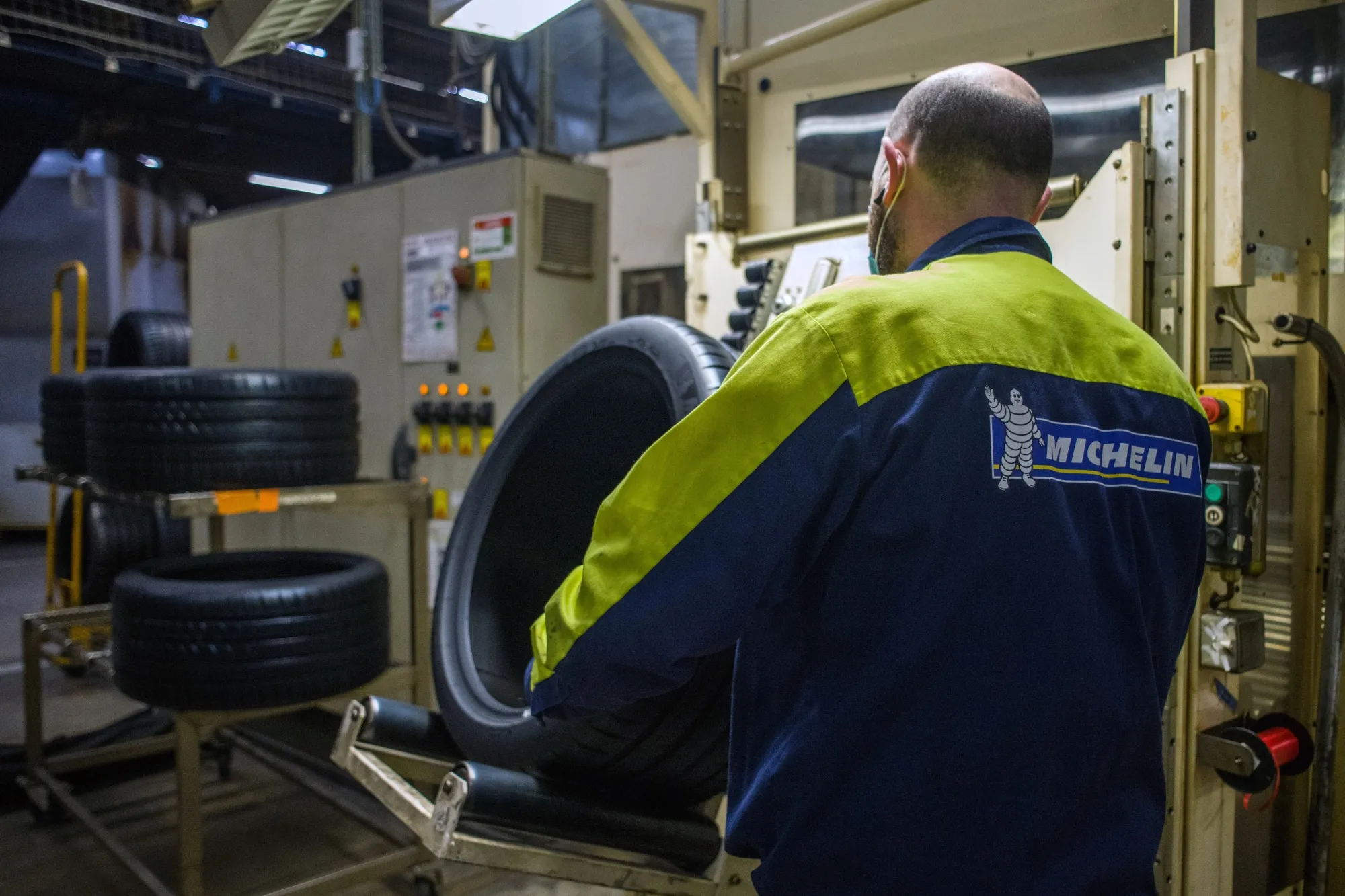 An employee checks a tire in the final finish area on the production line at the Michelin Gravanche manufacturing plant in Clermont Ferrand, France.