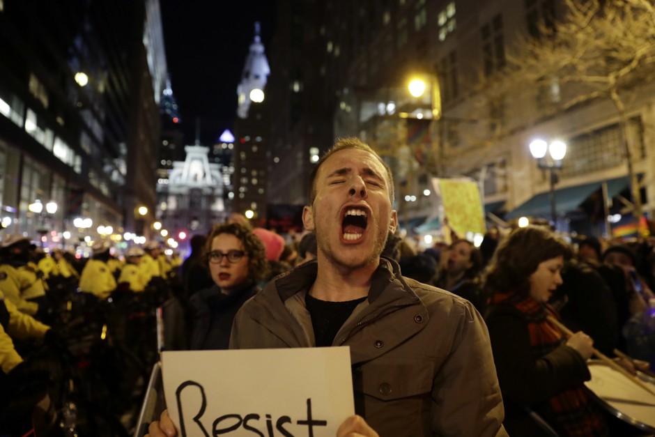 A protester yells outside the Republican congressional retreat in Philadelphia, Jan 2017.