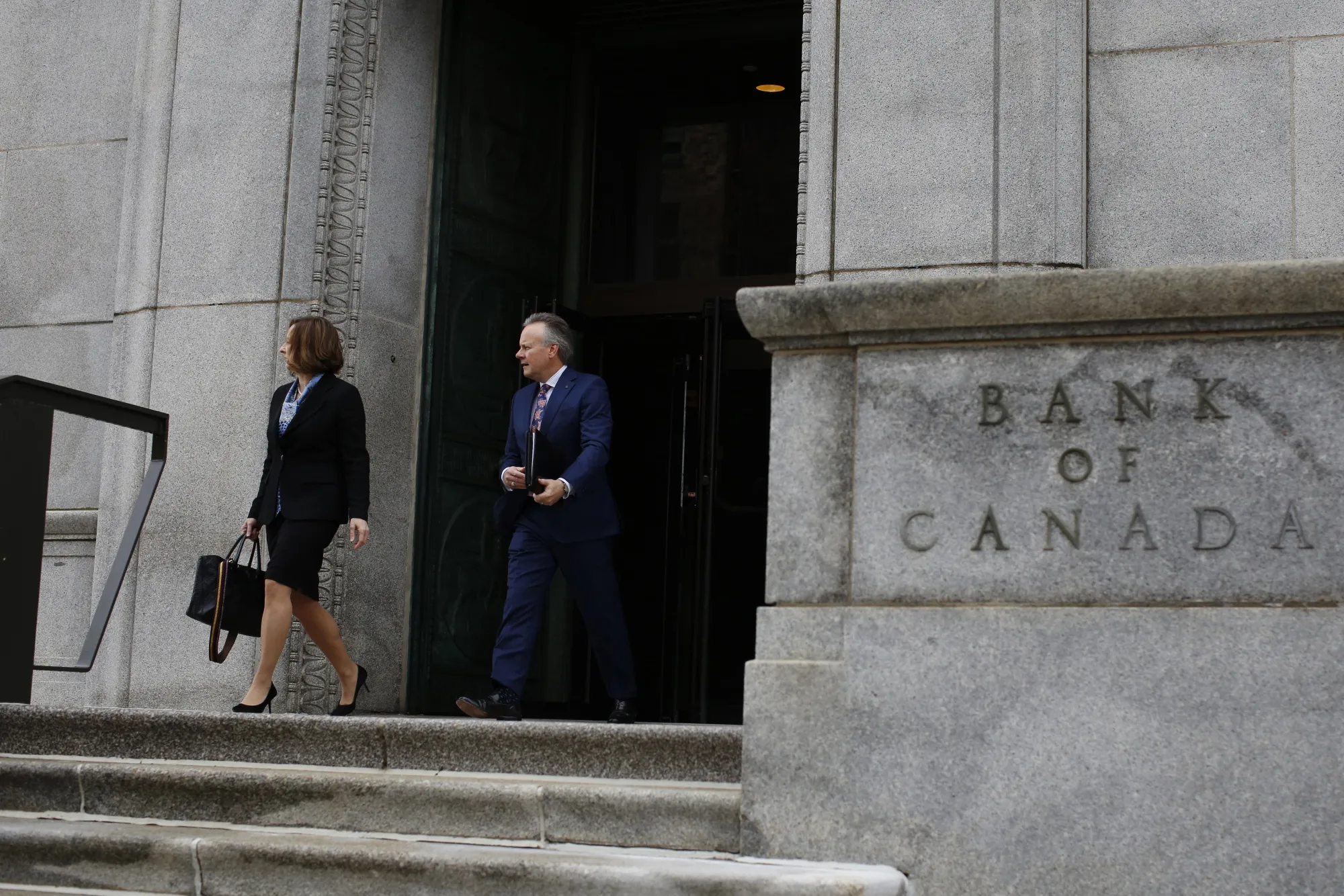 Governor Stephen Poloz and his senior deputy, Carolyn Wilkins, leave the Bank of Canada in Ottawa.