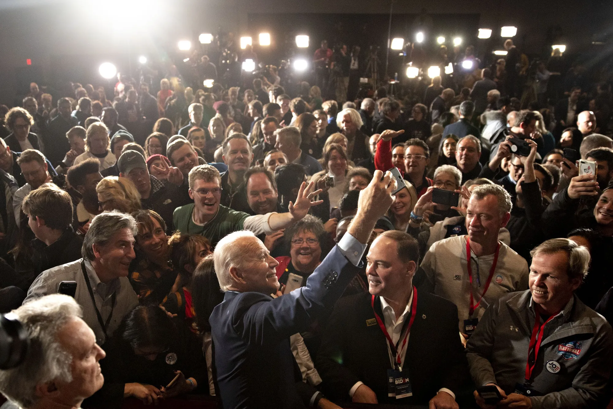 Joe Biden, center, takes a 'selfie' photograph with supporters during a caucus night watch party in Des Moines, Iowa, on Feb. 3.