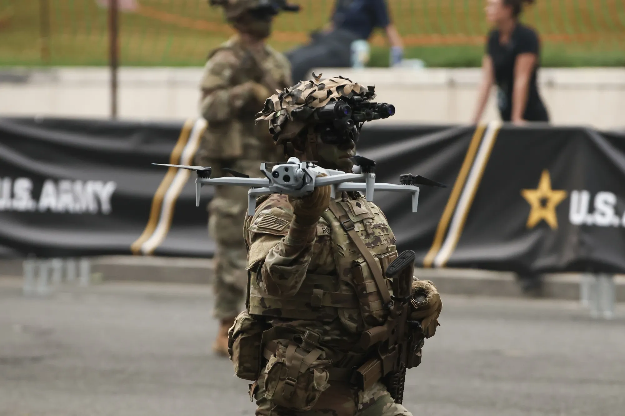 A soldier carries a drone during a military parade in Washington.