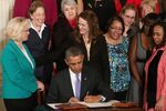 President Barack Obama is flanked by Lilly Ledbetter (left) and other women while signing an executive order banning federal contractors from retaliating against employees during an event in the East Room of the White House on April 8 in Washington.
