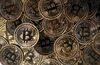 A collection of bitcoin tokens sit in this arranged photograph in London, U.K.