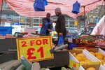A sign displays the price in pound sterling of food goods, including cucumbers, at a a fruit and vegetable market in stall east London on March 31, 2023. The UK economy performed slightly better than thought in the final quarter of last year, revised data showed Friday, but analysts warned of recession risks as inflation remains sky high. (Photo by Susannah Ireland / AFP) (Photo by SUSANNAH IRELAND/AFP via Getty Images)