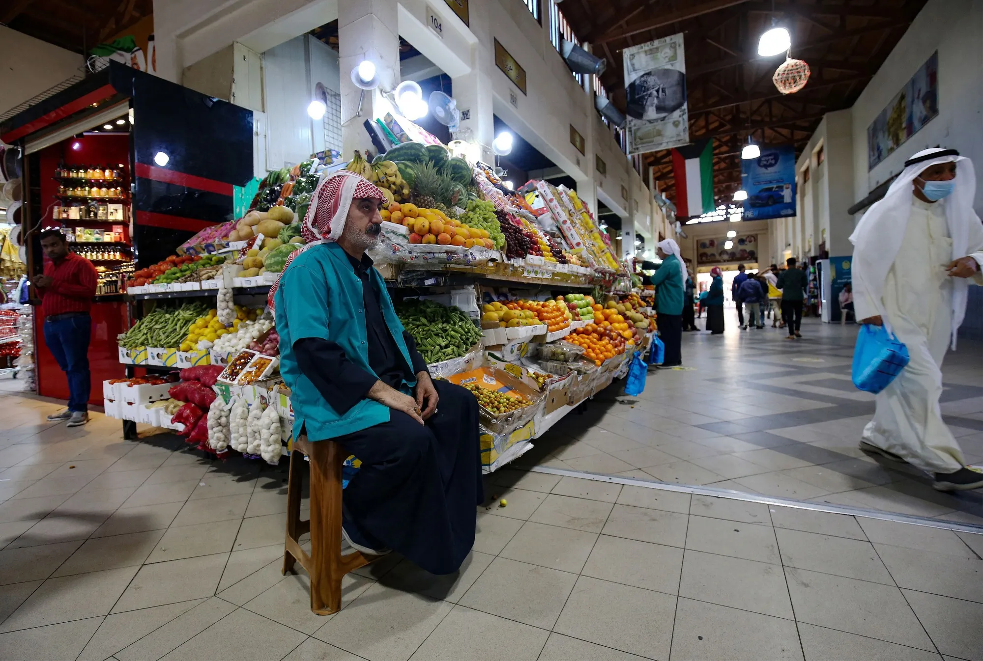 A vendor waits for customers at a food market in downtown Kuwait City.