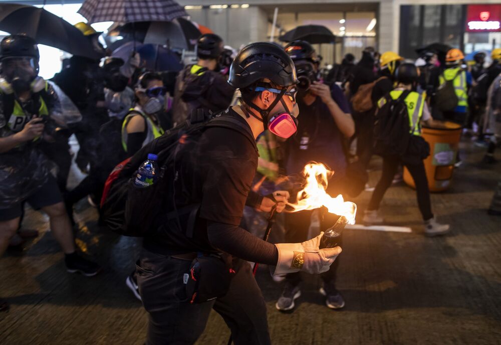 A demonstrator prepares to throw a fire bomb towards riot police in the Causeway Bay district of Hong Kong on Aug. 31, 2019.