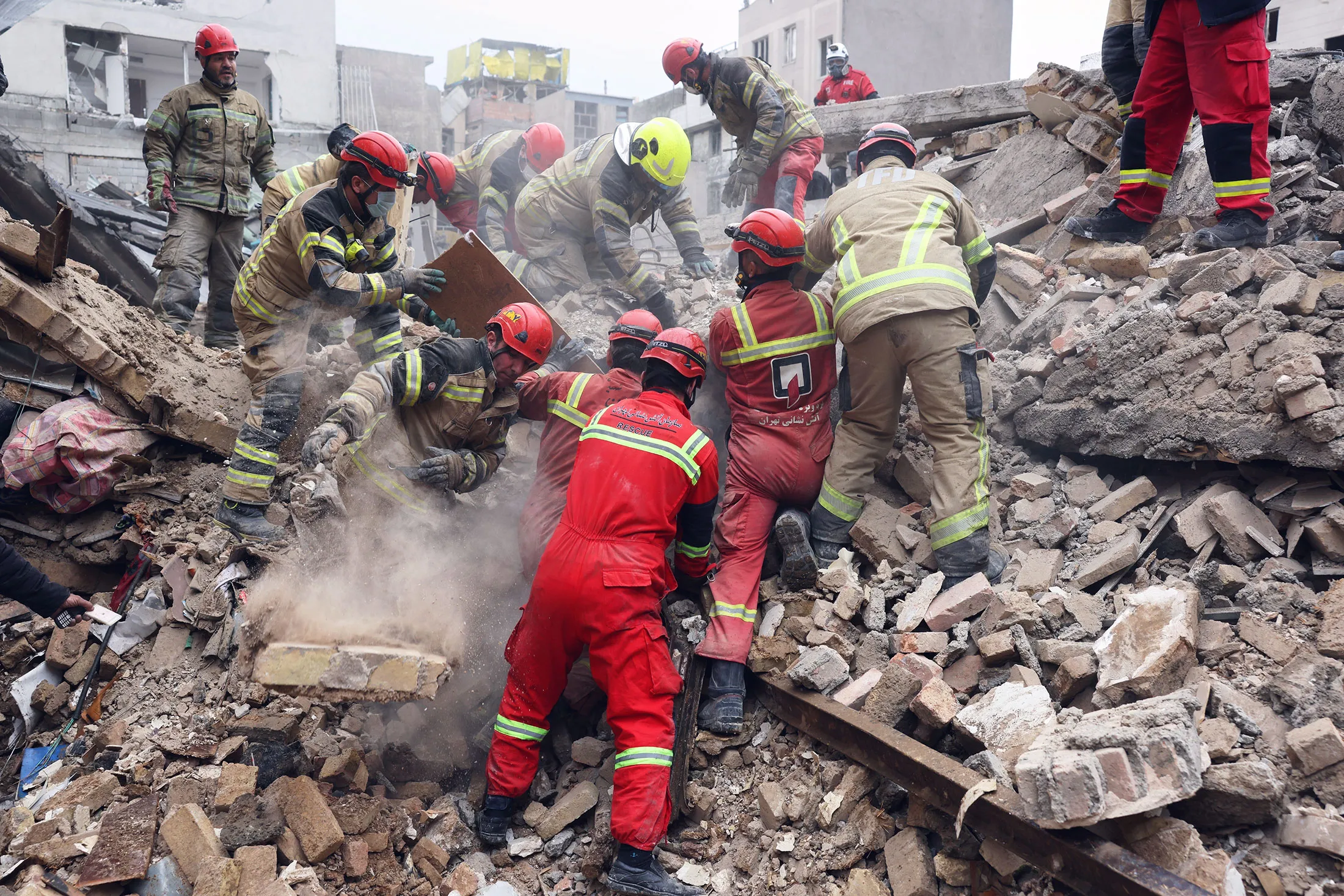 Rescue workers search for survivors following an airstrike in Tehran on March 13.