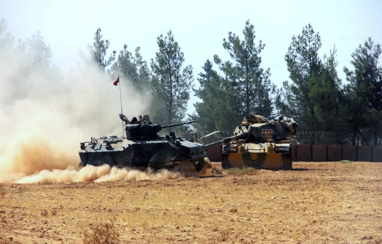 A Turkish army tank and an armored vehicle stationed near the border with Syria on Aug. 23.
