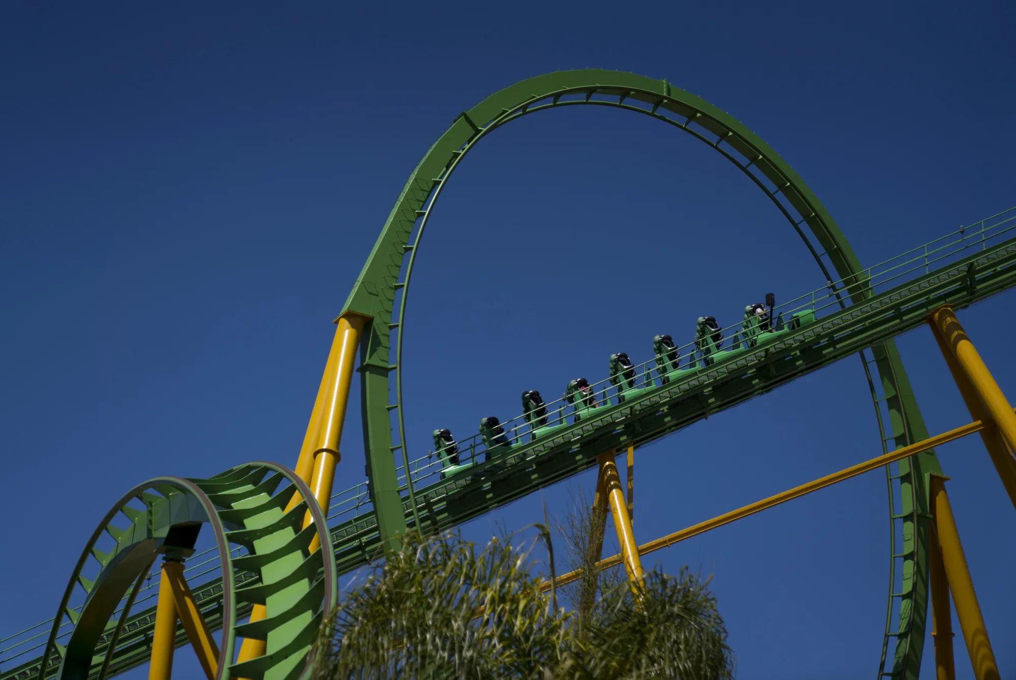 Visitors ride a roller coaster at the Six Flags Magic Mountain theme park in Valencia, California.
