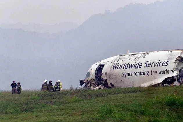 Fire crews at the site of a 2013 UPS cargo plane crash at Alabama's Birmingham-Shuttlesworth International Airport