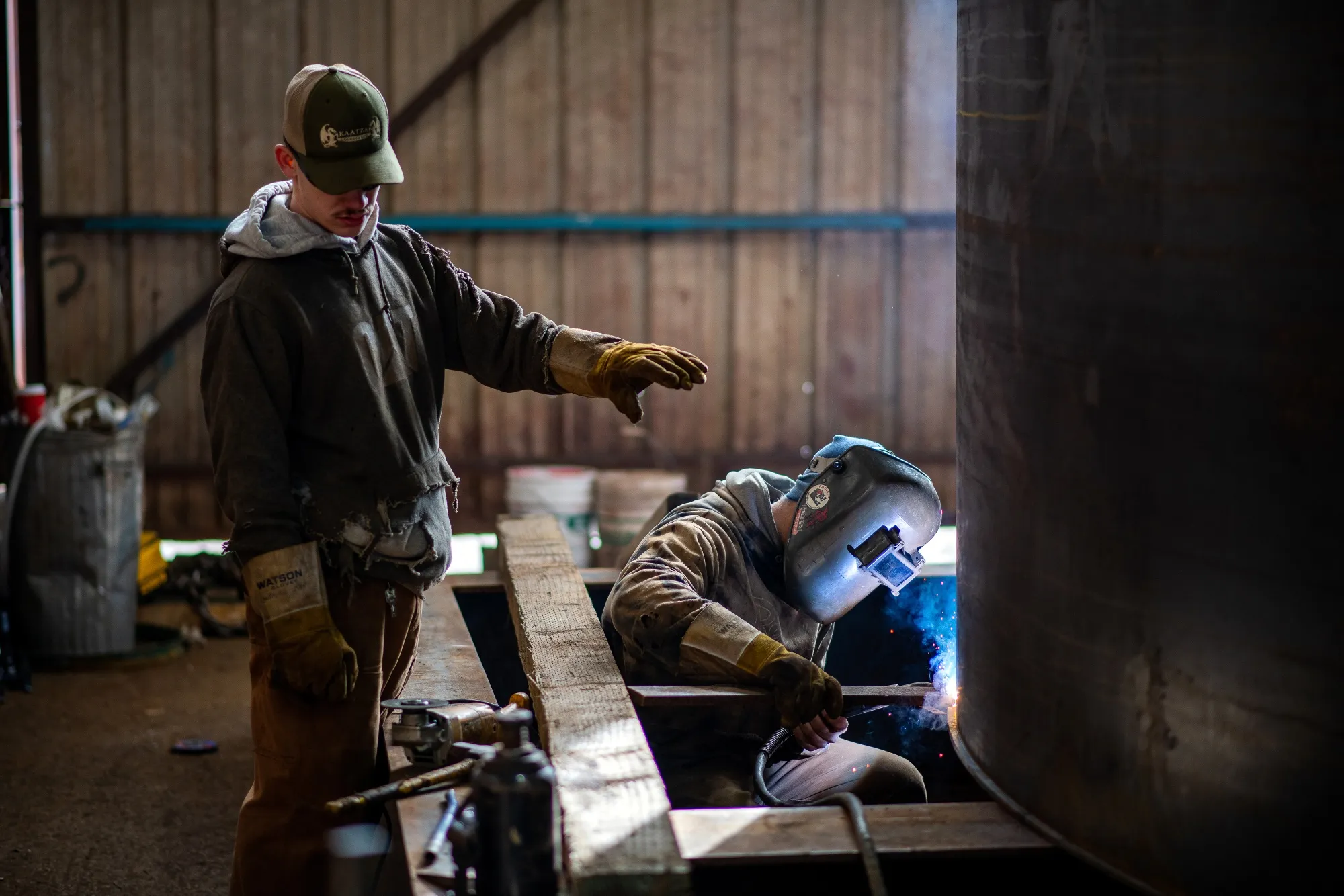 Workers weld a section of an industrial mooring dock in the steel fabrication shop near Duncan, British Columbia.