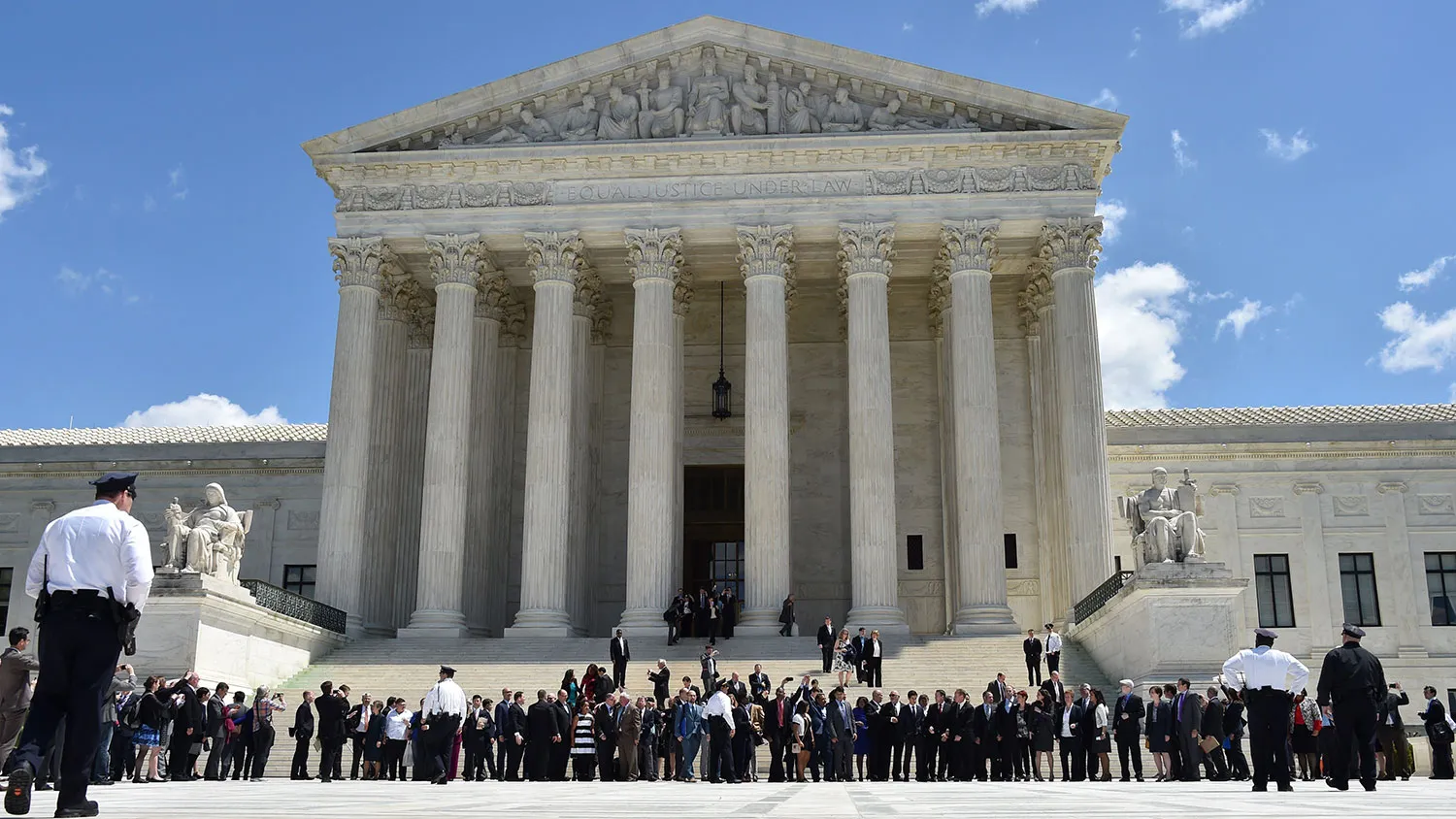 Gay couples and their legal teams, defending same-sex marriages cheer as they leave the US Supreme Court on April 28, 2014 in Washington, DC.
