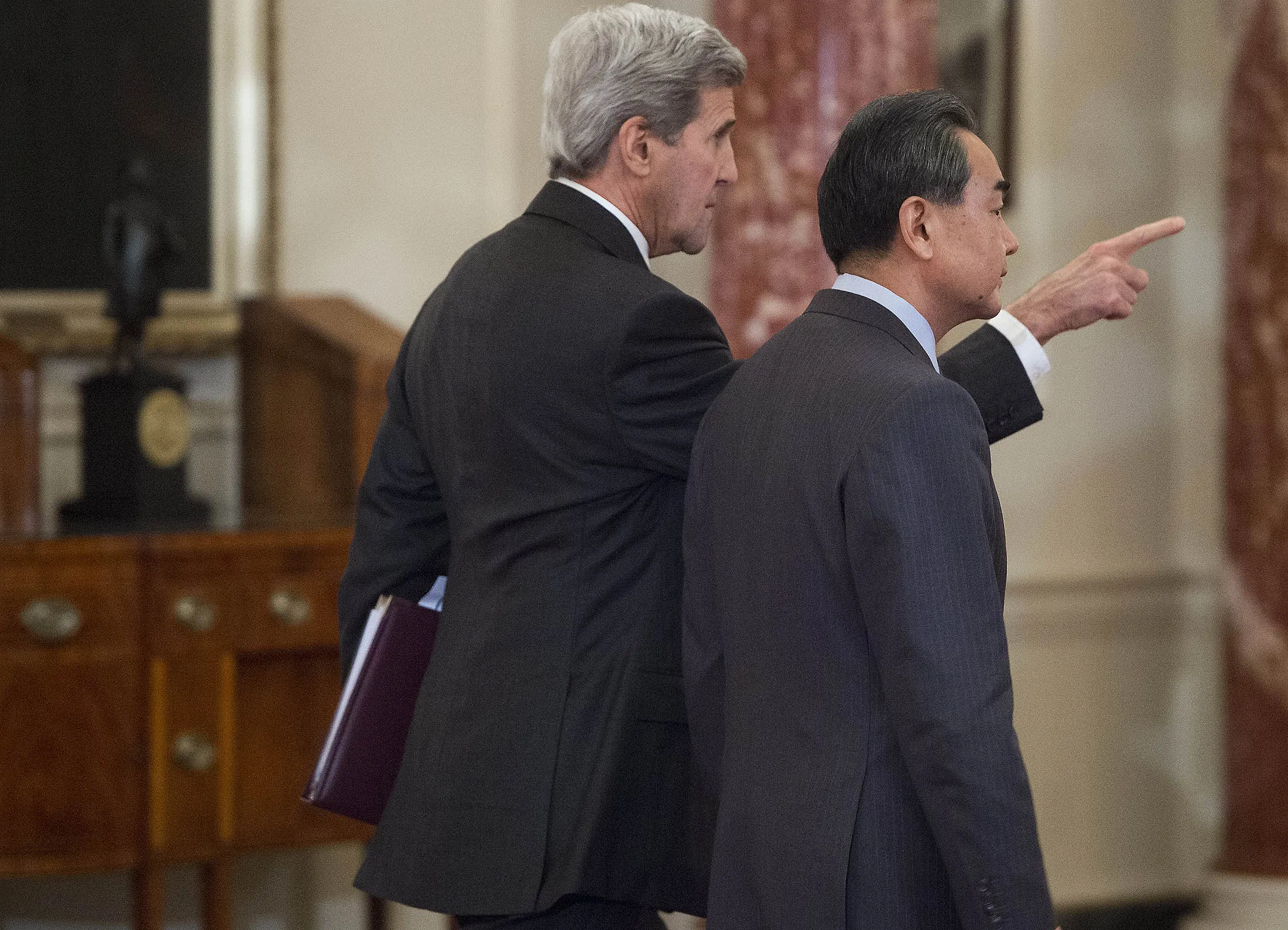 US Secretary of State John Kerry and Chinese Foreign Minister Wang Yi leave following a press conference at the State Department in Washington.
