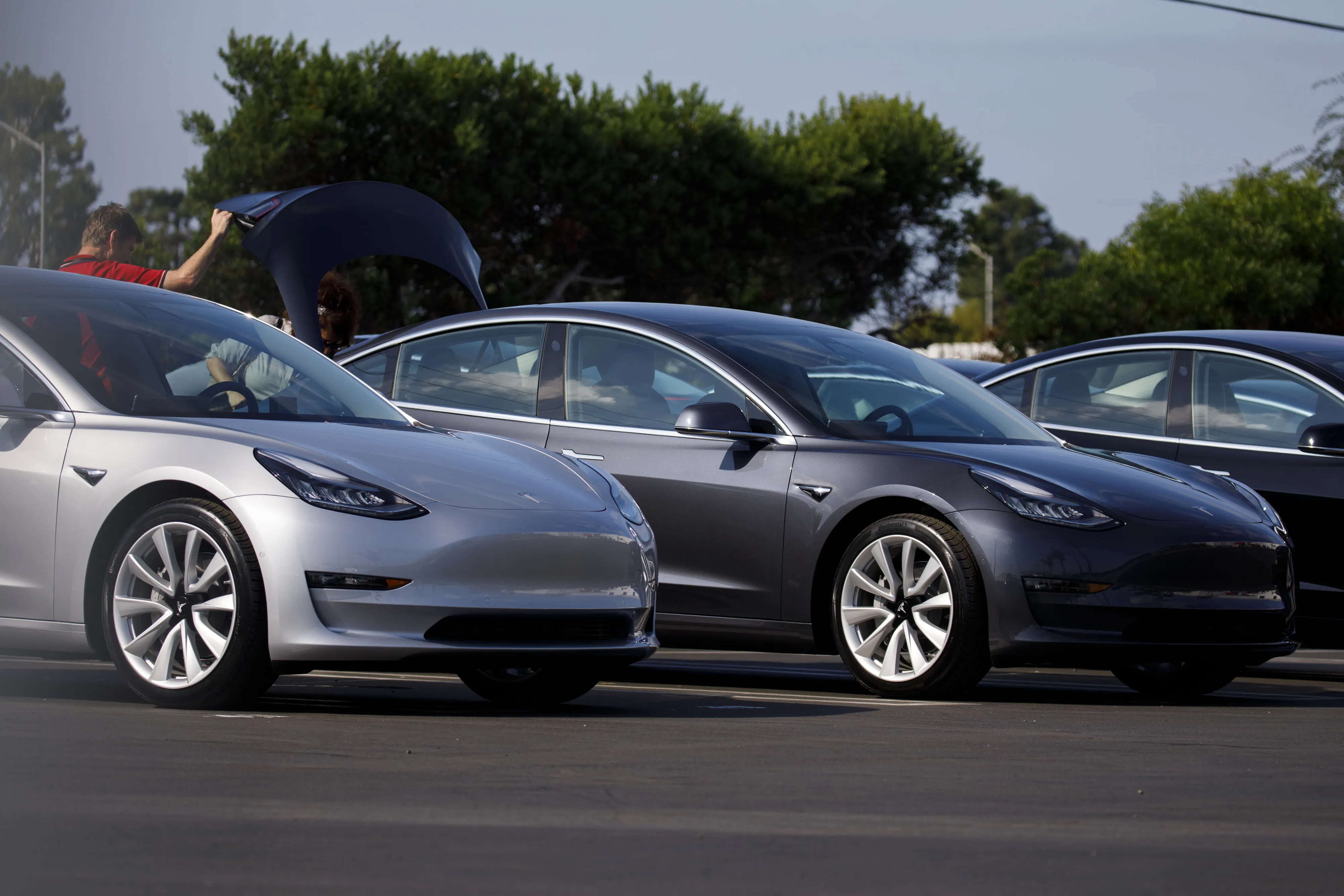 People look inside the trunk of a Tesla Inc. Model 3 electric vehicle at the company's delivery center in Marina Del Rey, California, U.S., on Saturday, Sept. 29, 2018. Tesla brought the total number of Model3 produced in the third quarter to over 51,000 vehicles.