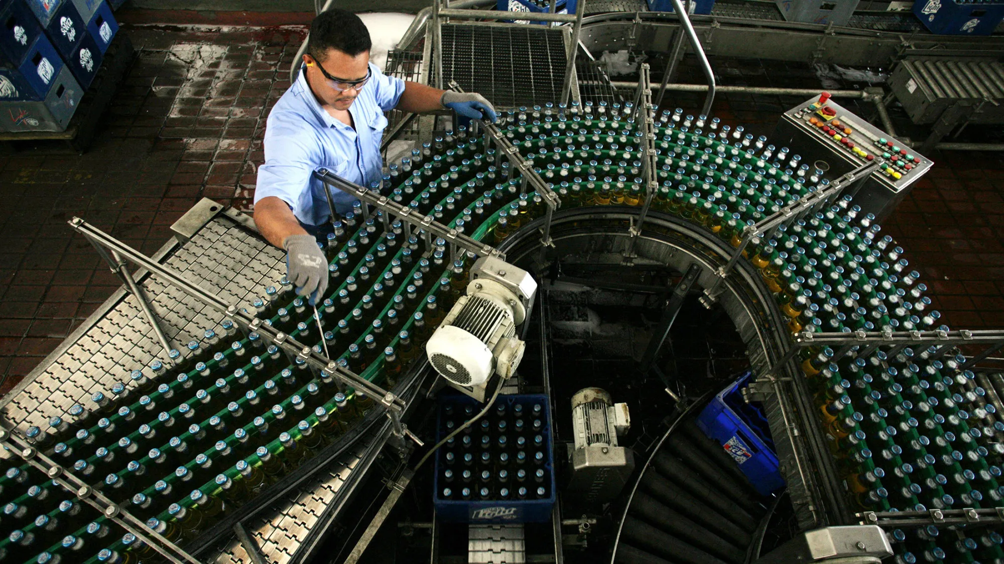 A worker at the production line of beer brewery Polar in San Joaquin, Carabobo state, 100 miles West from Caracas. Polar Group is the largest private corporation of Venezuela, and also the largest supplier of food and drinks of the country. Photographer Diego Giudice/Bloomberg News
