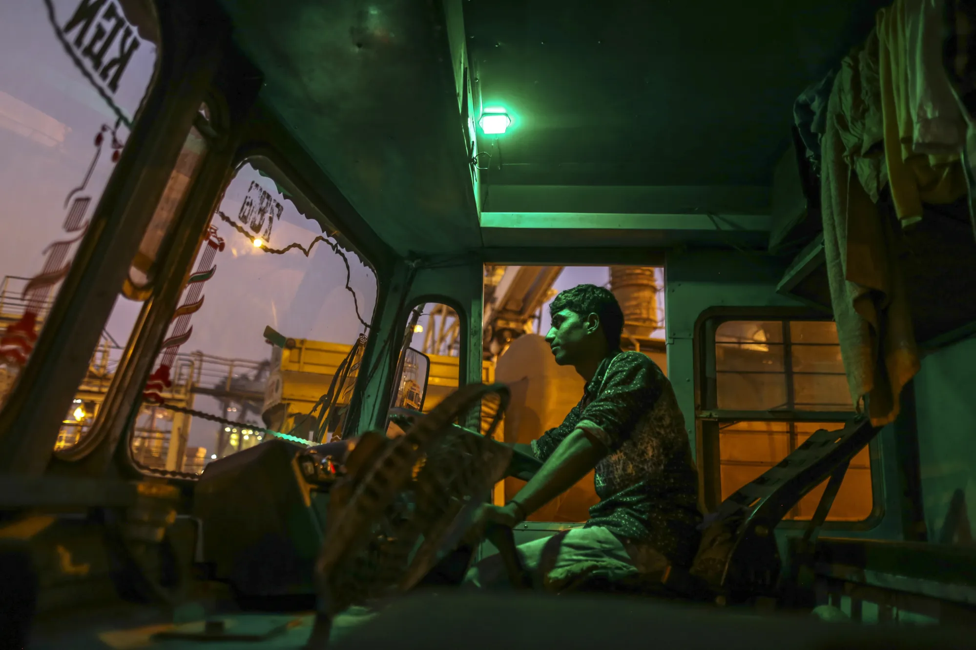 A driver sits inside the cabin of a cement tanker truck at the Jawaharlal Nehru Port&nbsp;in Navi Mumbai.