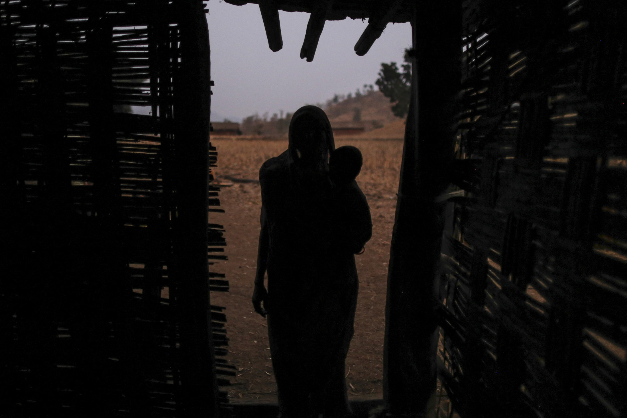 &nbsp;

A woman stands near her shack in Maharashtra's Bhamana village, where not a single home as access to electricity. More than 50 million homes are without power in India.
