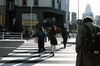Pedestrians walk across a road in the Shinjuku district of Tokyo, Japan, on Thursday, Nov. 19, 2020.