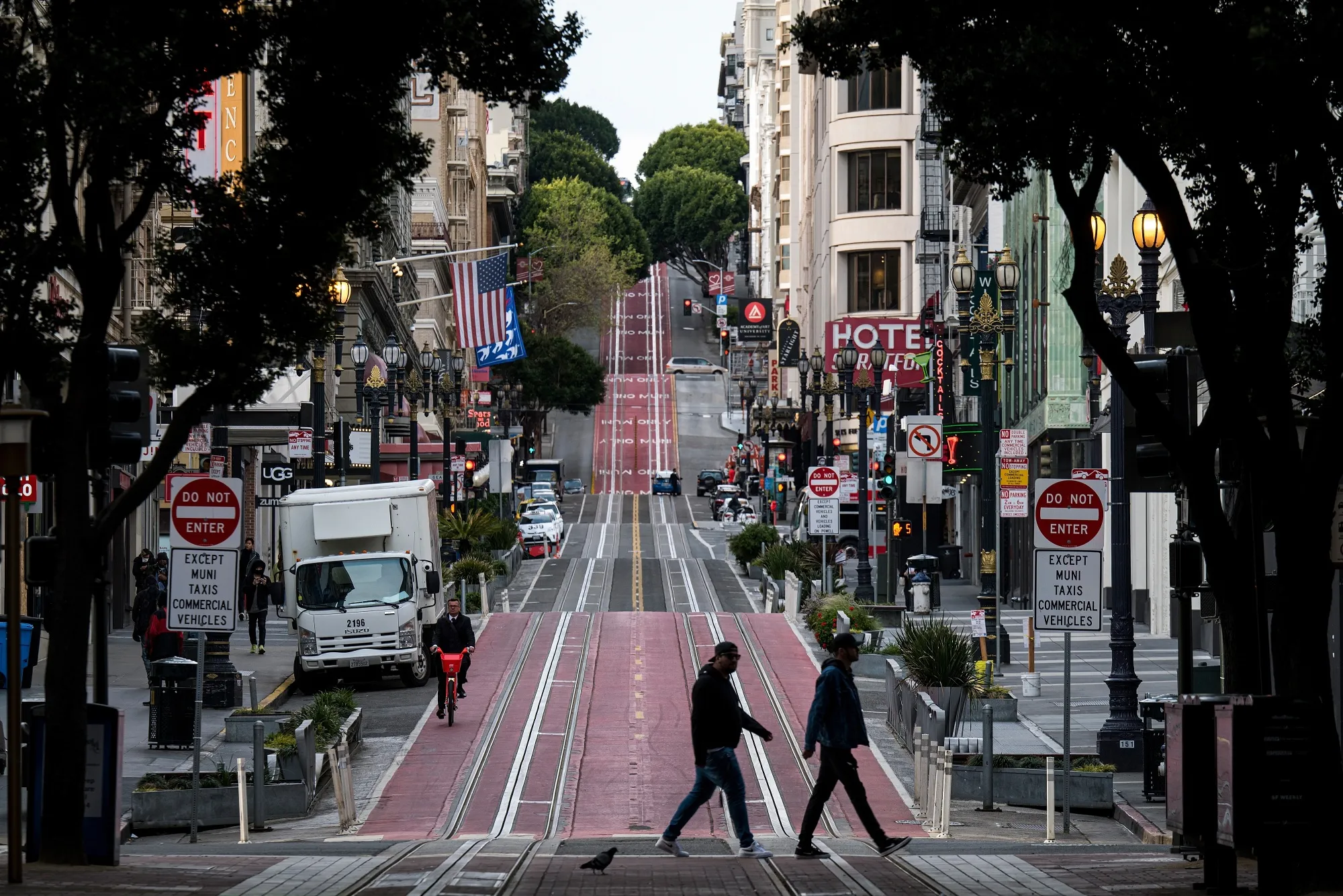 Pedestrians cross a&nbsp;nearly empty Powell Street in San Francisco.