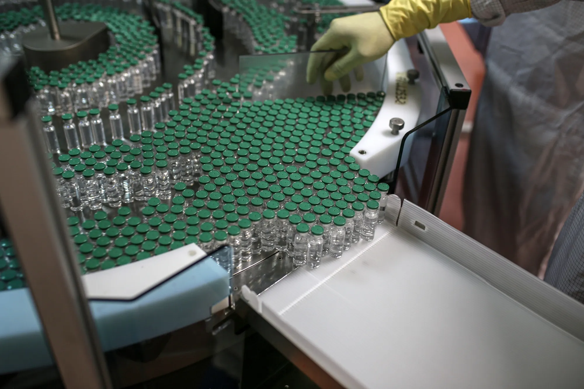 A worker&nbsp;monitors vials of Covishield on the production line at the Serum Institute of India&nbsp;plant in Pune, Maharashtra, India.