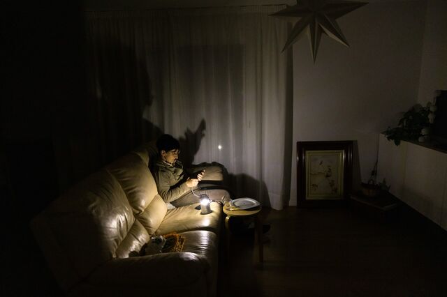 ■ A resident uses a torch light in her home during a power outage in Molins de Rei, Spain, in April.