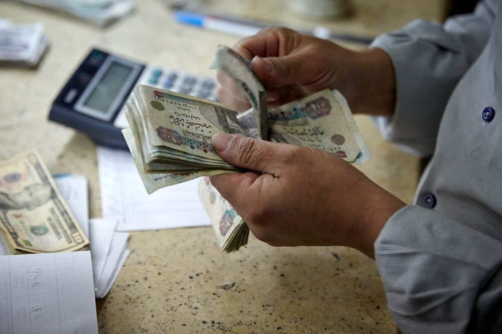 Egypt Lifts Remaining Currency Restrictions As Crunch Abates Bloomberg A Man Counts Egyptian Pounds Banknotes At Foreign Currency Exchange Bureau In Cairo Egypt