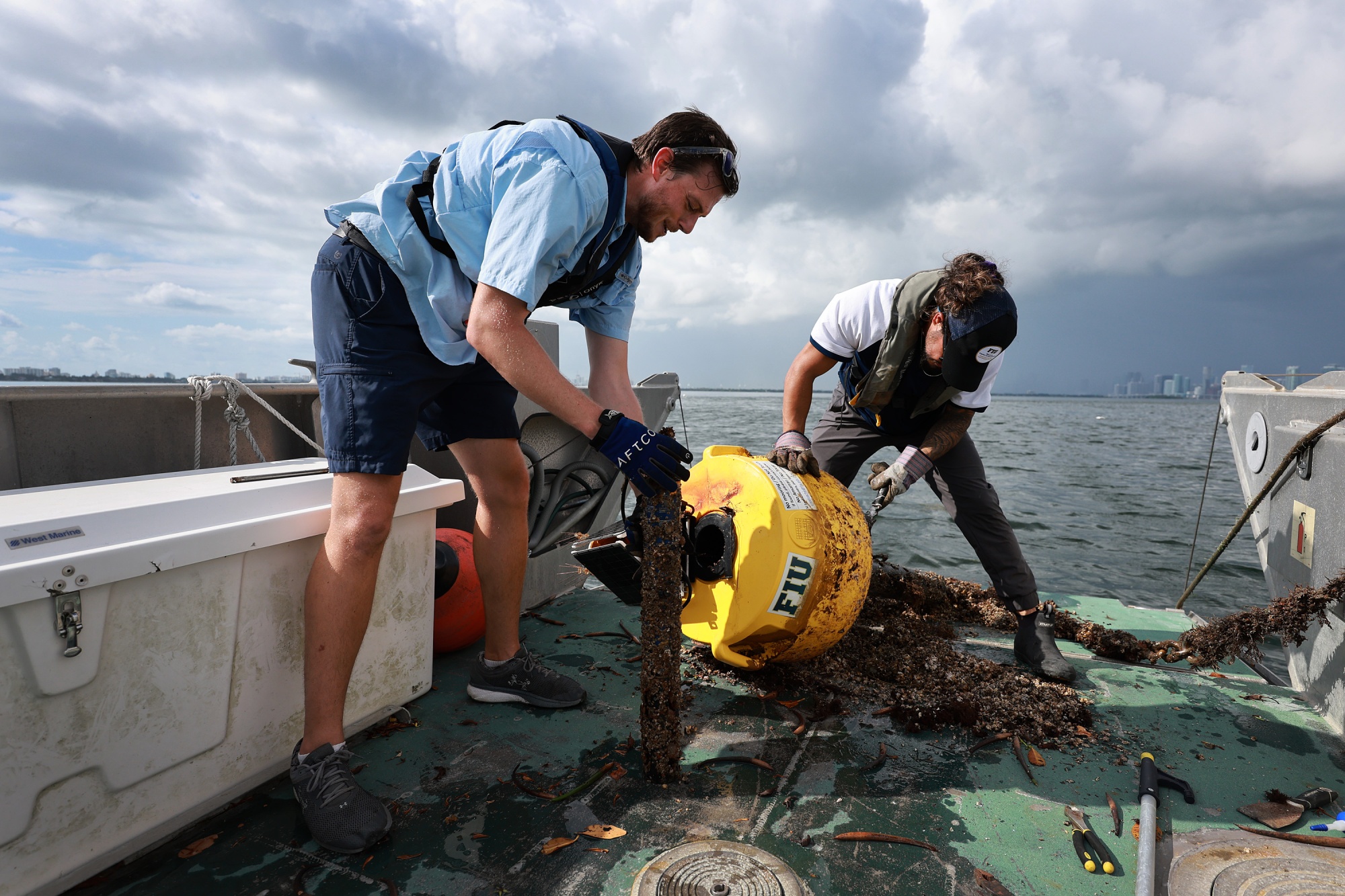 Researchers conduct routine maintenance on a research buoy in Biscayne Bay in Miami.
