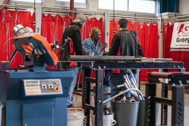 Welding instructor Barry Kennedy speaks to former students during the summer break in the welding classroom at Woodville Tompkins Technical & Career High School in Savannah.