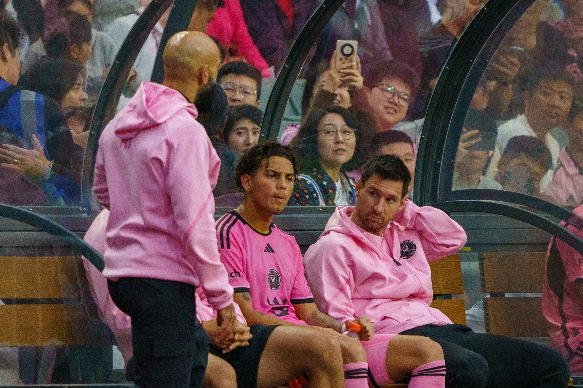 Lionel Messi, right, on the bench during a match between Inter Miami and the Hong Kong XI in Hong Kong on Feb. 4.