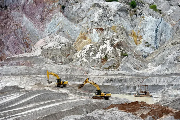 Excavators strip the overburden to reach tin ore in the mine pit at the PT Timah operations in Sungai Liat, Bangka Island, Indonesia, on Nov. 19, 2013