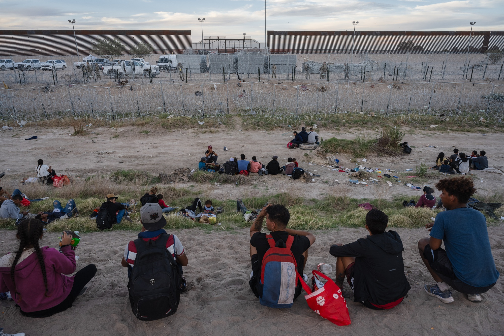 Migrants&nbsp;on the bank of the dry river bed of the Rio Grande at the US-Mexico border in Ciudad Juarez.