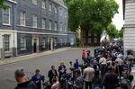 Members of the media report from outside 10 Downing Street in London, UK, on July 7.