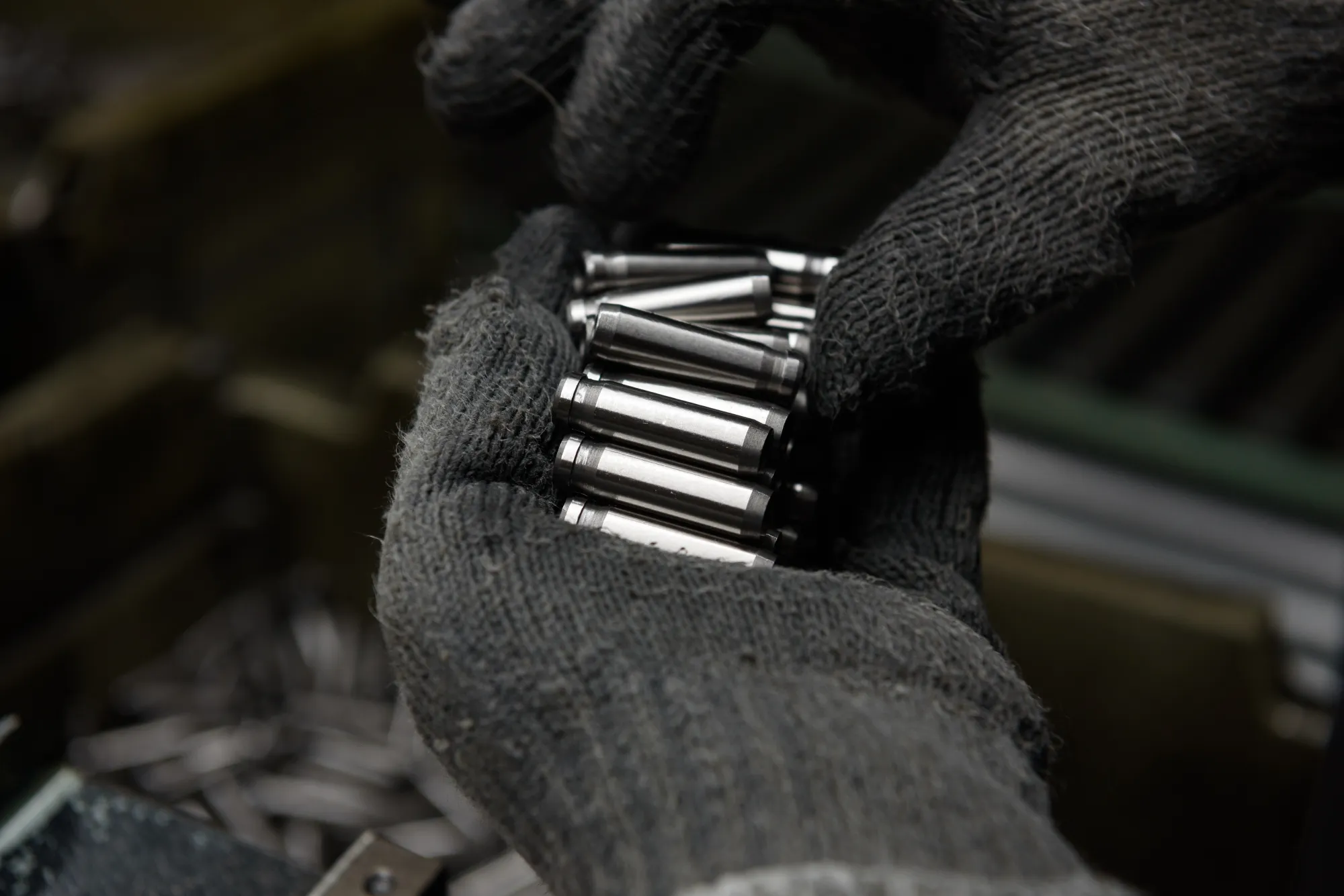 An employee inspects vehicle parts.