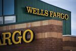 Signage is displayed outside a Wells Fargo & Co. bank branch in Palatine, Illinois.