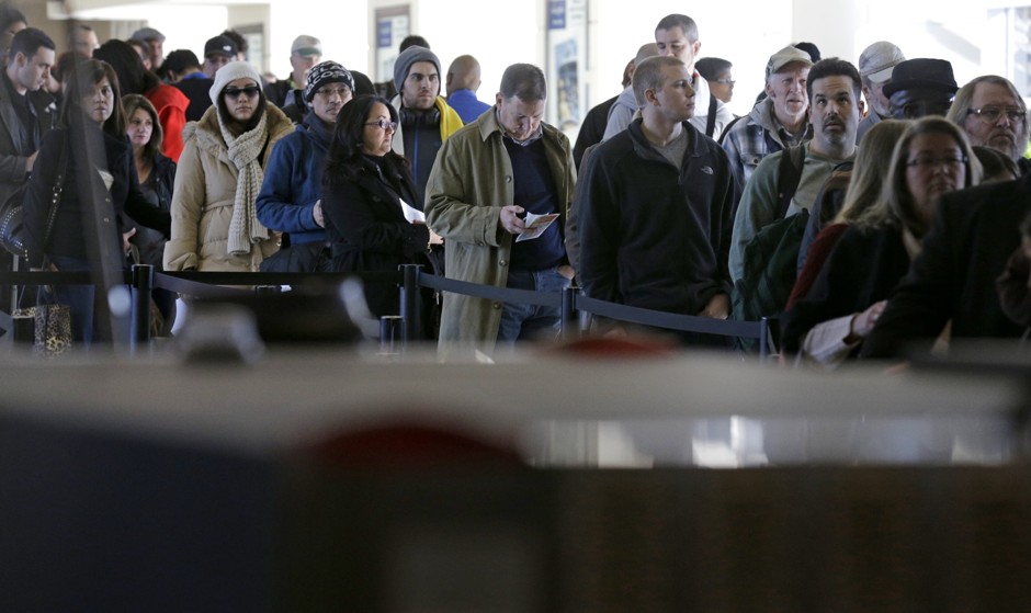 Travelers in line at a security checkpoint at Midway International Airport on November 21.