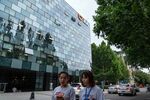 Pedestrians walk past the Didi Global Inc. headquarters in Beijing, China, on Monday, July 5, 2021.