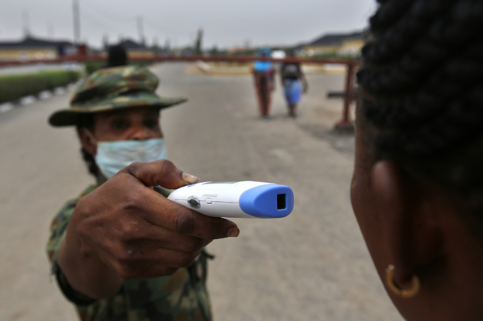 A member of the Nigerian army&nbsp;checks the temperature of&nbsp;a visitor at the entrance of the Nigerian Army Hospital, Lagos, Nigeria, on Feb. 28.&nbsp;