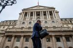 A pedestrian passes an entrance at the Bank of England in the City of London, U.K., on Thursday, Nov. 4, 2021.