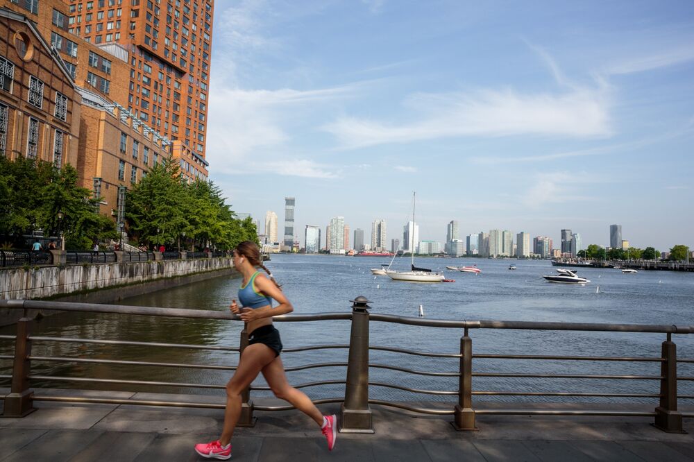 A jogger runs in downtown New York, U.S., on Wednesday, June 10, 2020. New York City, which experienced the biggest and deadliest Covid-19 outbreak in the country, began reopening on June 8.