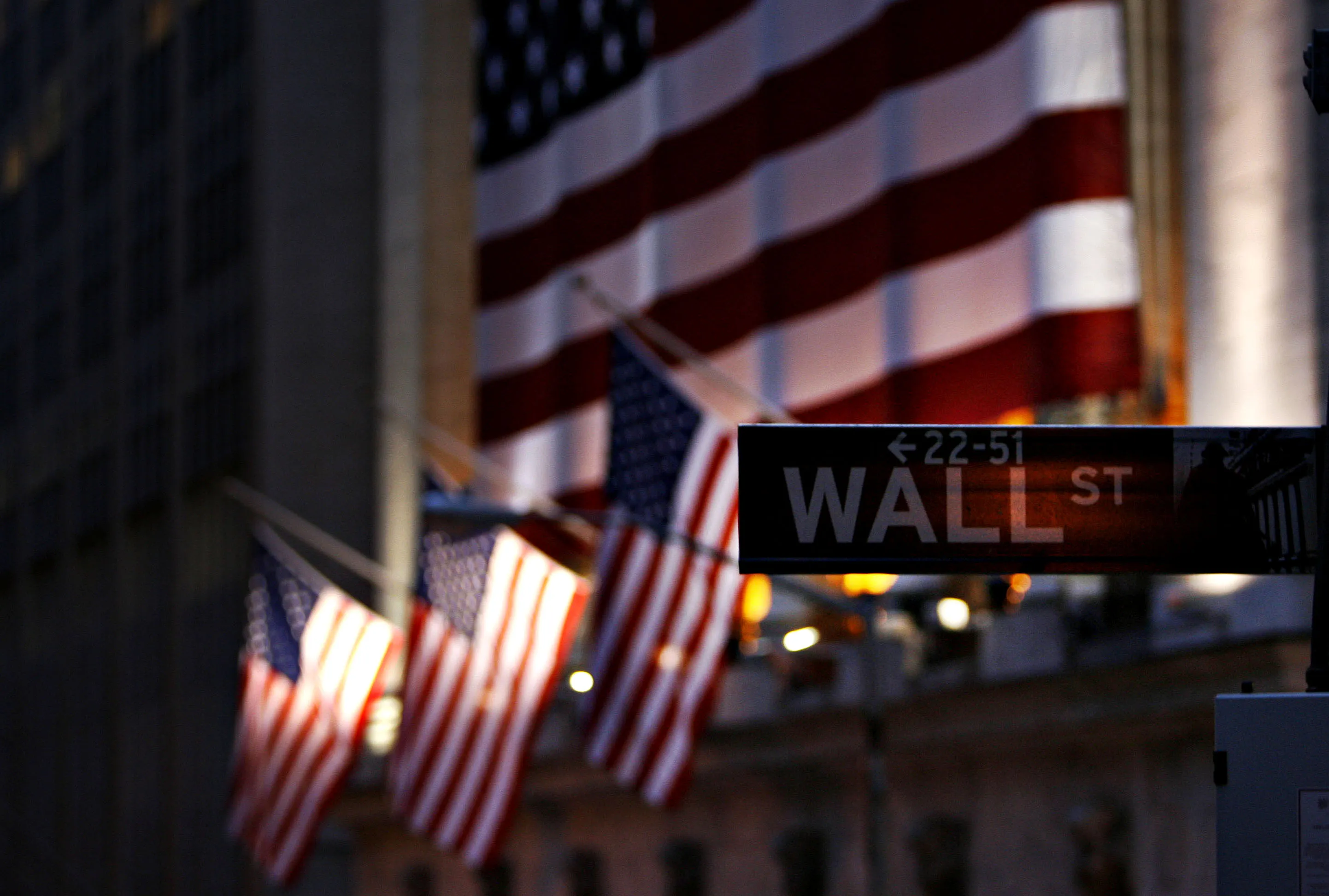 A Wall St. sign hangs outside the New York Stock Exchange, Tuesday, Feb. 27, 2007 in New York. U.S. stocks plunged, wiping out about $600 billion in market value and erasing all of the year's gains, after a selloff in China spread globally and sparked the biggest rout since the bull market began in 2002.
