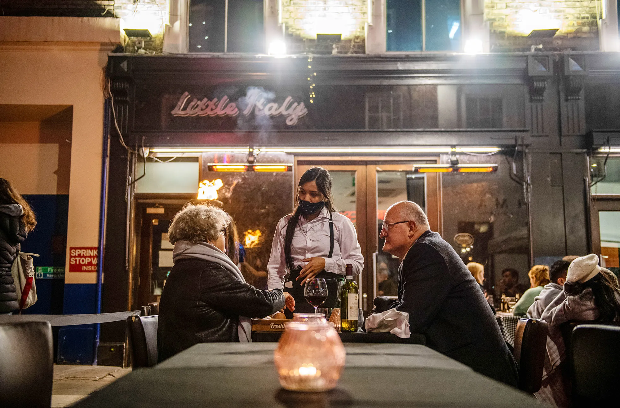 A waitress outside a bar in the Soho district, ahead of&nbsp;coronavirus lockdown, in London.&nbsp;