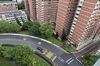 A car drives along a circular road, next to a residential block in Queenstown estate in Singapore, on Monday, Jan 15, 2018. Singapore sustained a comeback in home sales in December, boosting an annual tally that was already the highest since 2013.