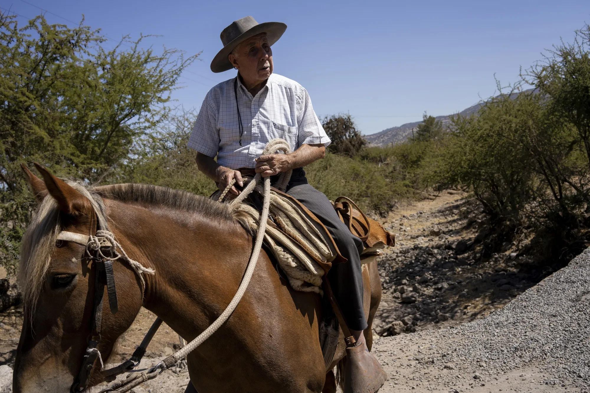 A person rides a horse through a dry river in Maule, Chile, in&nbsp;2020. An epic drought has sent Chilean water levels plummeting as much as 57% over the last decade.