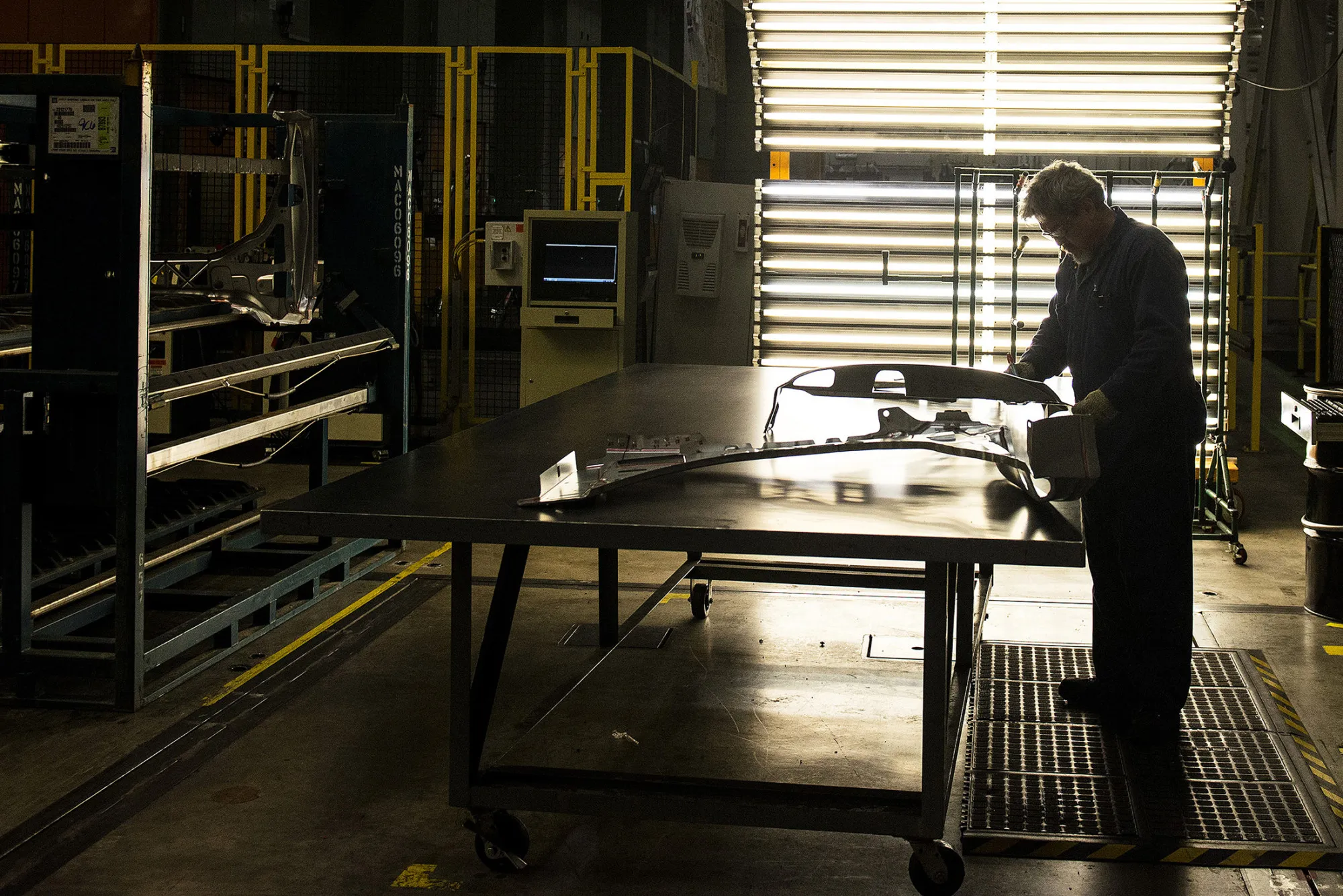 An employee inspects the quality of fenders during production at the General Motors Co. (GM) assembly plant in Arlington, Texas, on March 10, 2016.
