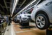 Automobiles move along the production line at a plant near Barcelona, Spain. 