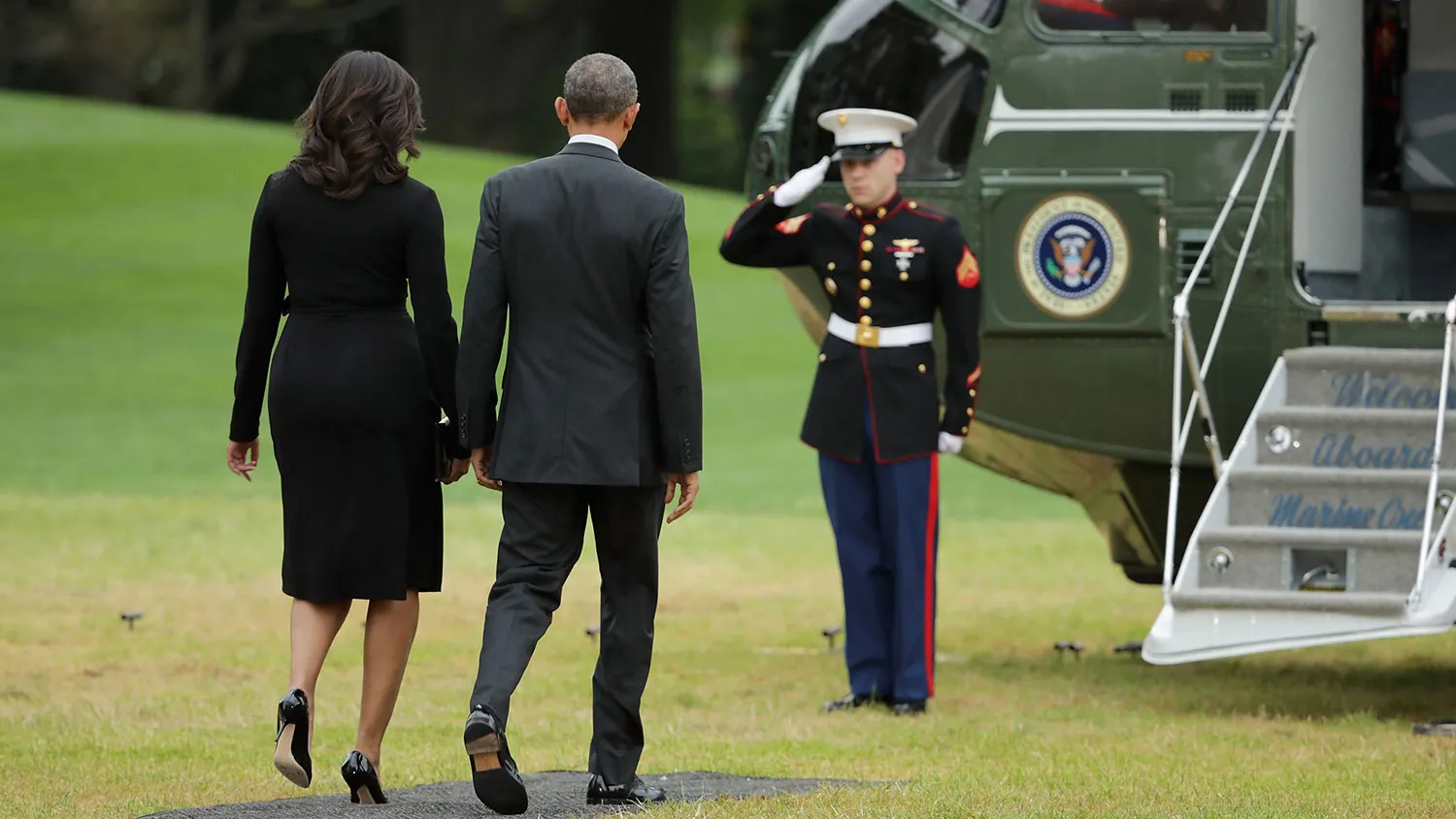 President Barack Obama and first lady Michelle Obama walk across the South Lawn before departing the White House on May 5, 2016, in Washington.
