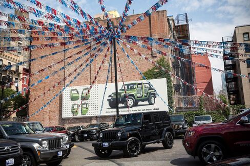 Jeep SUVs on display at a car dealership in New York City.